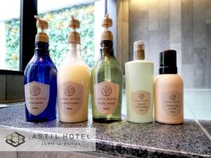 four bottles of essential oils sitting on a counter at Astil Hotel Juso Precious - Vacation STAY 16039v in Osaka