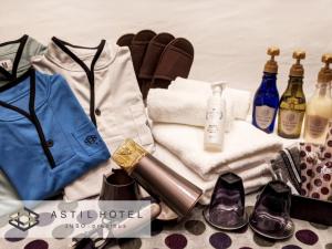 a pile of towels and clothes and a pile of shoes at Astil Hotel Juso Precious - Vacation STAY 16039v in Osaka
