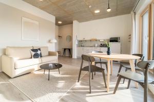 a living room with a couch and a table at dreamcation Apartments - Boardinghouse Straubing Süd in Straubing