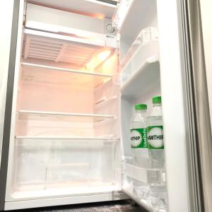 an open refrigerator filled with milk and juice at Suksomboon Residence in Bangkok