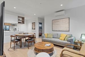 a living room with a couch and a table at Zi apartments - with Balcony, Bayview, Sauna and Pool in Melbourne