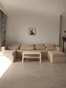a living room with a couch and a table at Amazing waterfront Apartment in Hurghada