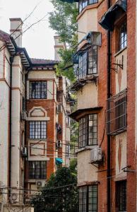 a group of tall brick buildings with windows at Shanghai Downtown Flower B&B in Shanghai
