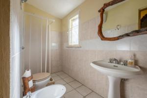 a bathroom with a toilet and a sink at Gufo in Pitigliano +25 photos