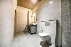 y baño con aseo y lavamanos. en FabHotel Naina Residency en Rāiwāla