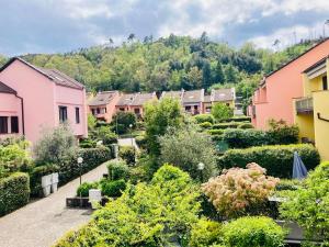 a row of houses with bushes and trees at Casa vacanze alle Cinque Terre in Soviore