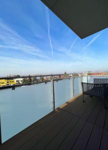 a balcony with a bench and a view of the water at AgaApartments in Słupca
