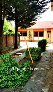 a pole in the grass in front of a house at Strigonia Apartman in Esztergom