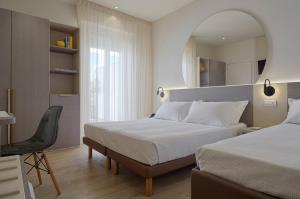 Postel nebo postele na pokoji v ubytování Hotel La Fenice + 37 fotografií