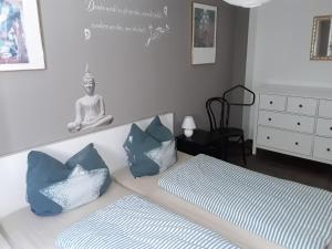 a bedroom with a bed with a statue on the wall at Ferienwohnung Strandkorb in Glücksburg