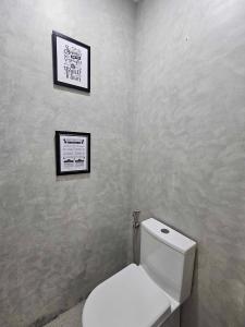 a bathroom with a toilet and a picture on the wall at Kasa Boutique Hotel in Cebu City