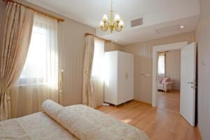 a bedroom with a bed and a chandelier at Setenonu 1892 Hotel in Kayseri