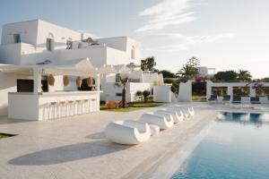 a villa with a swimming pool and white buildings at DUNES - Semi Based Apartment with Indoor Garden - Part Of White Dunes Luxury Boutique Hotel in Santa Maria