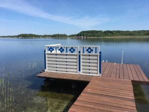 a dock on a body of water at Ferienhaus am See in Krakow am See +15 photos