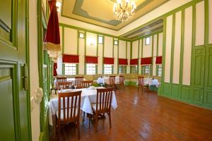 a dining room with tables and chairs and a chandelier at Setenonu 1892 Hotel in Kayseri