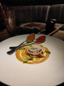 a plate of food on a white table at Red Orchid Hotel Kanpur in Kānpur