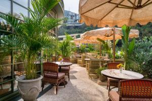 an outdoor patio with tables and chairs and plants at Island Shangri-La, Hong Kong in Hong Kong