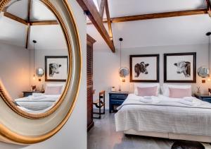 a bedroom with two beds and a mirror at The Cattle Shed in Wighton