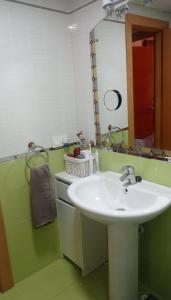 a bathroom with a sink and a mirror at Ático con terraza en el puerto de Aguadulce in Aguadulce
