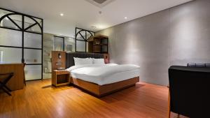 Postelja oz. postelje v sobi nastanitve Hotel Schweizer Dorf Cheonan