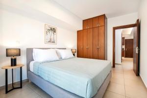 a bedroom with a large white bed and a table at Gaia 1 - 5 min to Beach in Kos