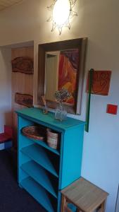 a blue dresser with a mirror in a room at TUTTO House&Home in Lubno