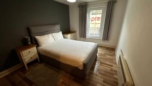 a small bedroom with a bed and a window at 2 Bedroom Flat Ground Floor Town Centre Colchester in Colchester