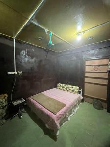 um quarto com uma cama com um cobertor rosa em Lai Tada Homestay Sarikei em Sarikei