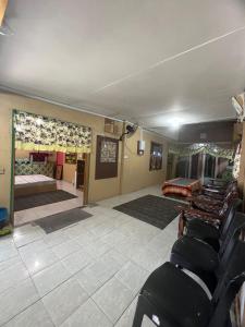 a living room with a bed and a room with chairs at Lai Tada Homestay Sarikei in Sarikei