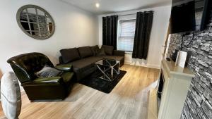 a living room with a couch and a fireplace at One Bedroom Flat Town Centre Colchester in Colchester