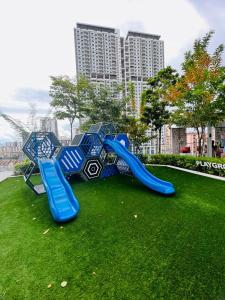 a blue slide on the grass in a park at Urban Suites by PerfectSweetHome with Spectacular High View# Komtar View in Jelutong
