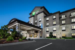 a hotel with a parking lot in front of it at Holiday Inn Express Conway by IHG in Conway