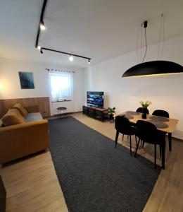 a living room with a couch and a table at Apartament Asnyka Centrum in Nowy Sącz
