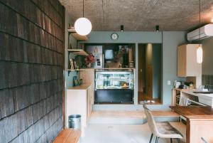 a kitchen with a counter and a refrigerator at Sumida Nagaya in Tokyo