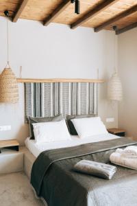 a bedroom with a large bed with white pillows at White and Grey 2 in Mikonos