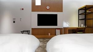 Postelja oz. postelje v sobi nastanitve Hotel Schweizer Dorf Cheonan