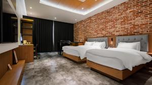 Postelja oz. postelje v sobi nastanitve Hotel Schweizer Dorf Cheonan