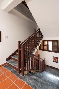 uma escada de madeira num quarto com paredes brancas em Hoianese Heritage Hotel - Truly Hoi An em Hoi An