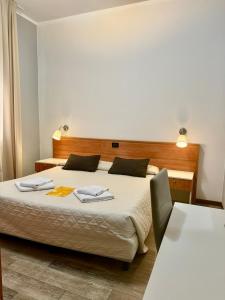 a hotel room with a bed and two tables at Hotel Delle Rose in Mestre