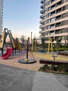 a playground in a city with slides and play equipment at Fully furnished , luxury, site with Pool in Ankara