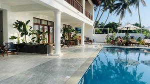 a villa with a swimming pool and a resort at Sea Star Boutique Hotel in Hikkaduwa