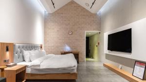 Postelja oz. postelje v sobi nastanitve Hotel Schweizer Dorf Cheonan