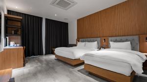 Postelja oz. postelje v sobi nastanitve Hotel Schweizer Dorf Cheonan