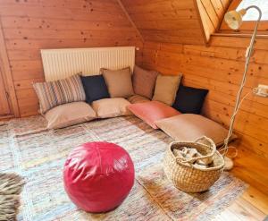 a room with a couch and pillows in a cabin at ForrestHouse in Zetea