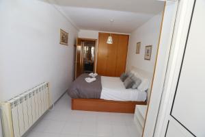 a small bedroom with a bed and a staircase at DIFFERENTFLATS Aquario in La Pineda +7 photos