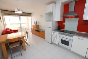 a kitchen with a table and a dining room at DIFFERENTFLATS Aquario in La Pineda