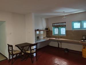 a kitchen with a table and chairs in a room at Home sweet in Ahanagama villa in Ahangama