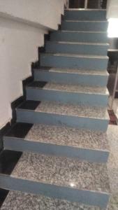 a set of stairs in a hallway with blue paint at OYO Holidayinn in Kargil