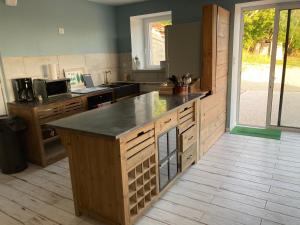 a kitchen with a large island in the middle at Gîte N°2 : YLMADI in Cahors