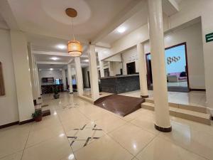 a lobby of a building with columns and a lobby at Victoria Rock Resort in Entebbe